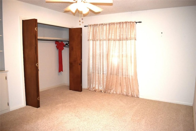 unfurnished bedroom featuring a closet, ceiling fan, and carpet