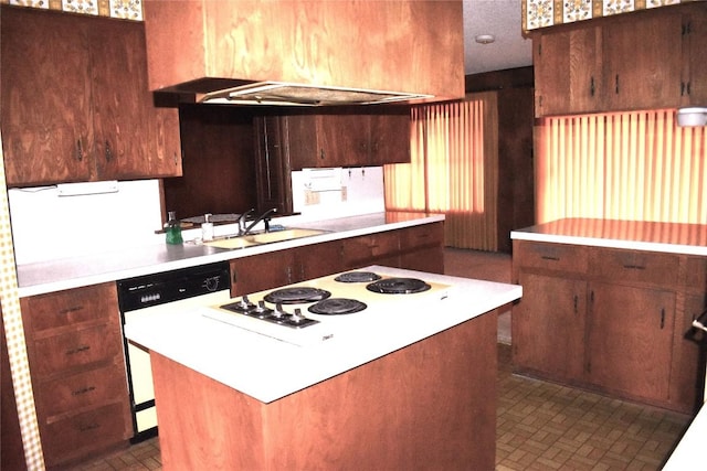 kitchen with cooktop, sink, and dishwashing machine