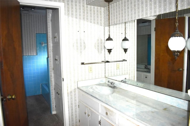 bathroom featuring vanity and a tub to relax in