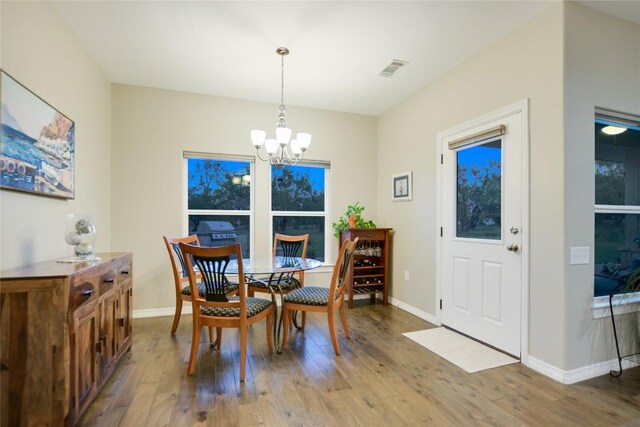 dining space featuring a notable chandelier and hardwood / wood-style flooring