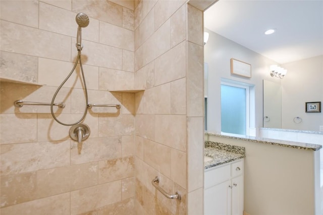 bathroom featuring vanity and tiled shower