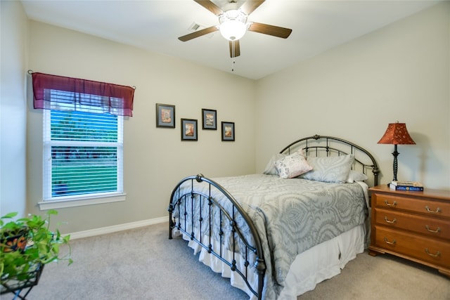 bedroom featuring ceiling fan and light colored carpet