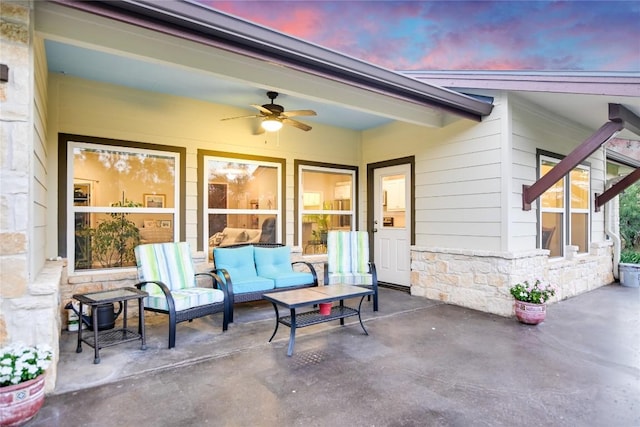 patio terrace at dusk featuring outdoor lounge area and ceiling fan