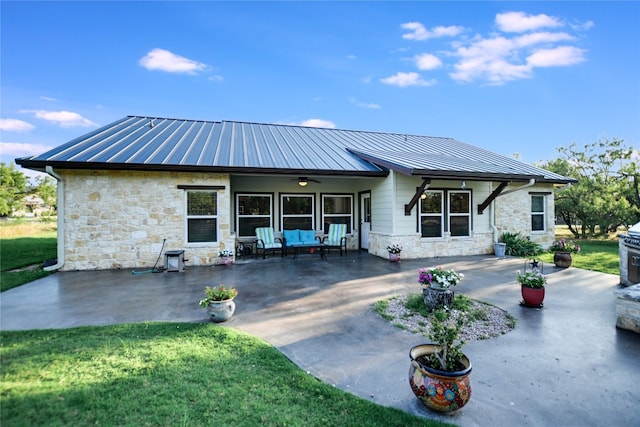 back of property with a yard, ceiling fan, and a patio