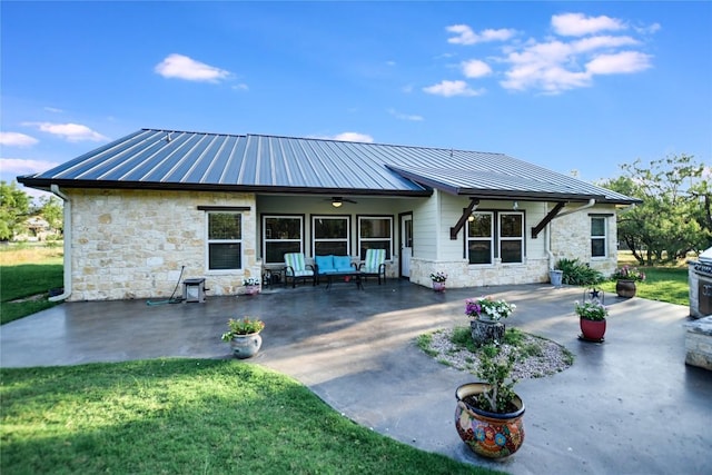 1502 Hi Cir S, Horseshoe Bay, TX 78657 - back of house featuring stone siding, a patio, a standing seam roof, and metal roof