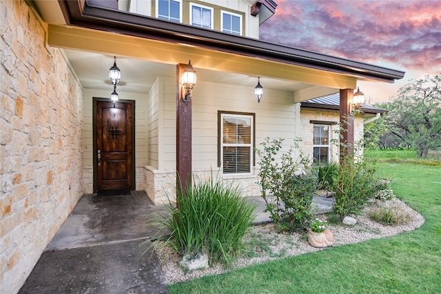 exterior entry at dusk with a yard