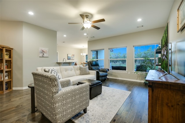 living room featuring ceiling fan and dark hardwood / wood-style floors