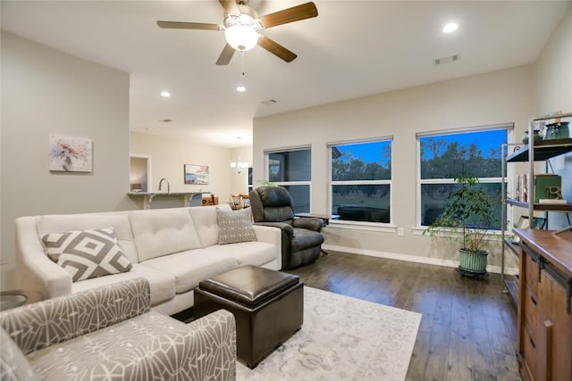 living room with wood-type flooring and ceiling fan