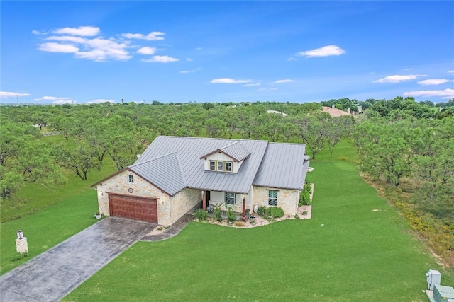 1502 Hi Cir S, Horseshoe Bay, TX 78657 - view of front of house featuring stone siding, an attached garage, driveway, a front lawn, and metal roof