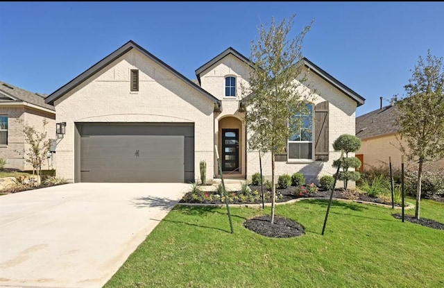 view of front of house with a garage and a front lawn