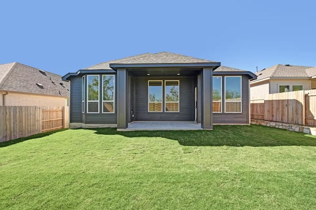 back of house with a patio and a yard