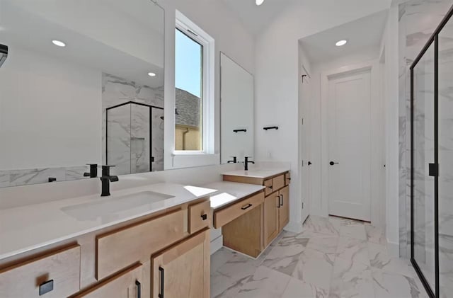 bathroom featuring vanity, a wealth of natural light, and a shower with shower door