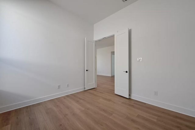 spare room with light wood-type flooring