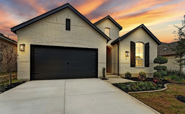 french country style house featuring a garage