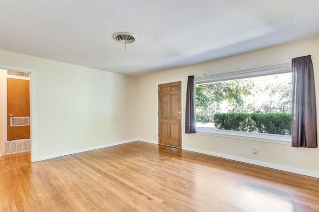 empty room with light hardwood / wood-style floors