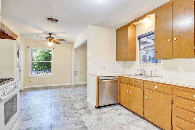 kitchen featuring white range with gas stovetop, sink, stainless steel dishwasher, and ceiling fan