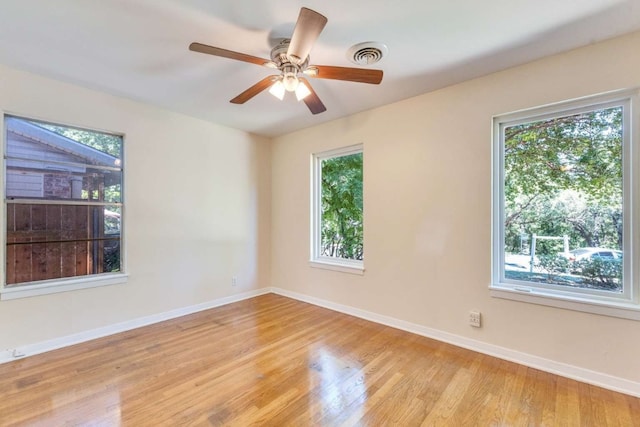 unfurnished room with ceiling fan, light hardwood / wood-style flooring, and plenty of natural light