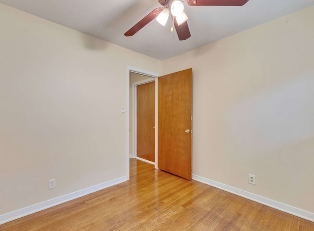 empty room with ceiling fan and light hardwood / wood-style floors