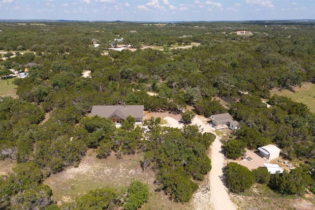 bird's eye view featuring a wooded view