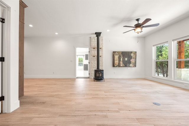 unfurnished living room with recessed lighting, light wood-style flooring, and baseboards