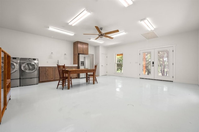 dining room with french doors, finished concrete flooring, attic access, ceiling fan, and washer and dryer