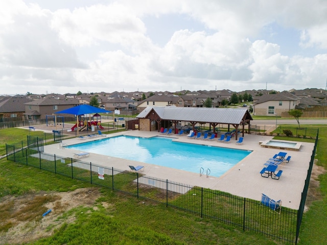 view of pool featuring a patio, a playground, and a yard