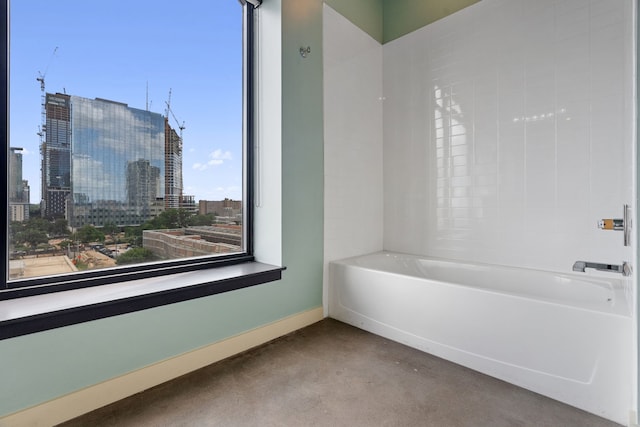 bathroom featuring concrete flooring and a bathtub