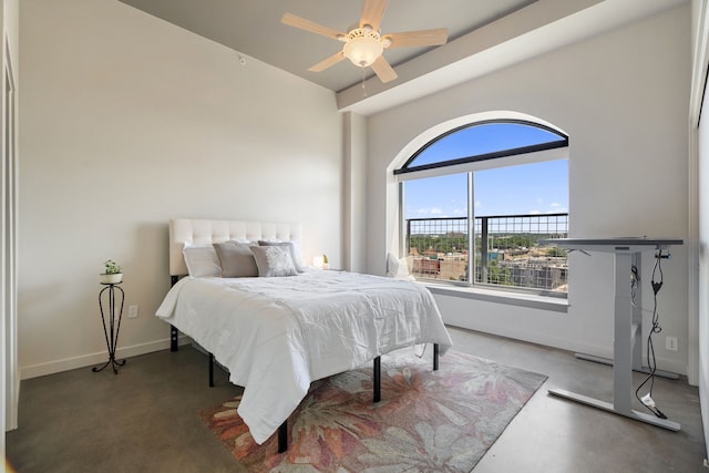 bedroom with ceiling fan and concrete floors