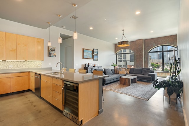 kitchen featuring sink, beverage cooler, concrete floors, backsplash, and light brown cabinets