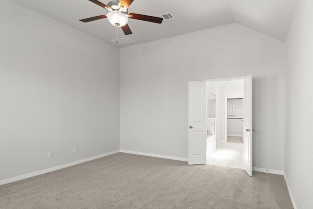 empty room with lofted ceiling, light colored carpet, and ceiling fan