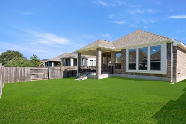 back of house featuring a yard