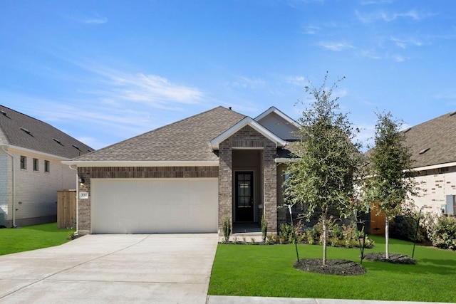 view of front facade with a garage and a front yard