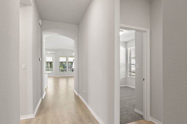 corridor with light hardwood / wood-style floors