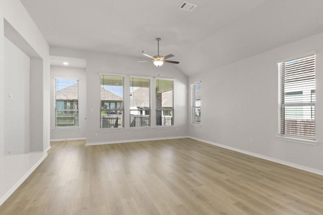 unfurnished living room with light wood-type flooring, ceiling fan, and vaulted ceiling