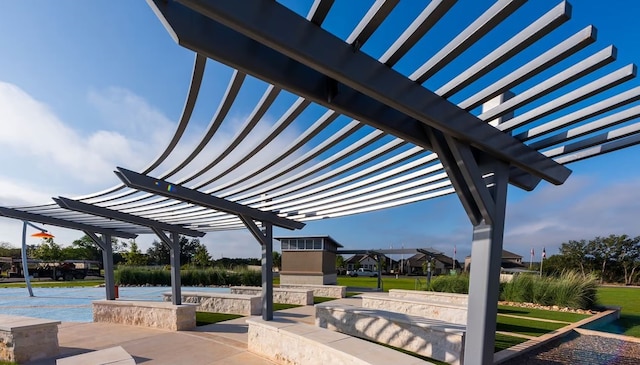 view of home's community with a pergola and a water view