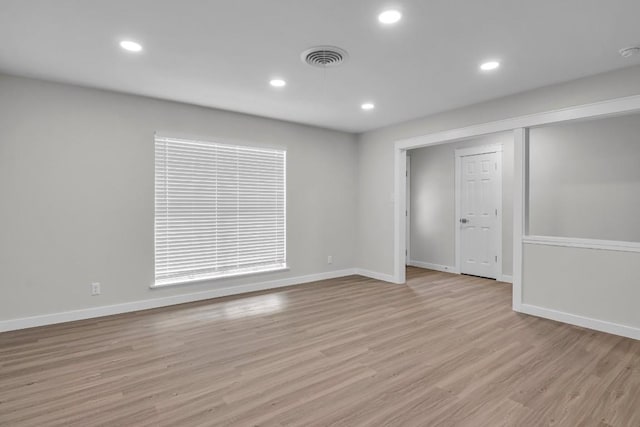 unfurnished room with light wood-type flooring