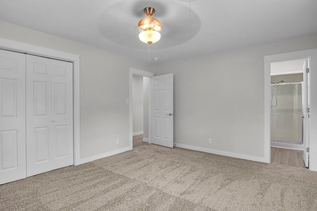 unfurnished bedroom with ceiling fan, light carpet, and a closet