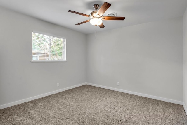 carpeted spare room featuring ceiling fan