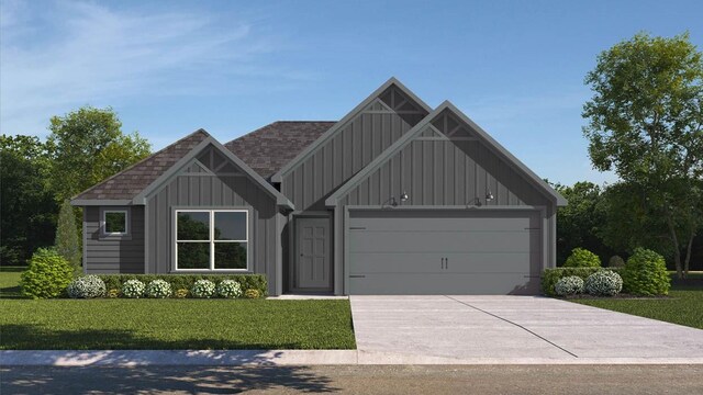 view of front of property with a garage and a front lawn