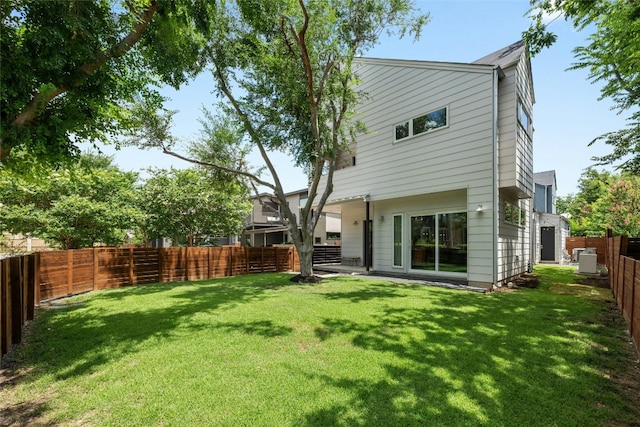 rear view of property featuring a lawn