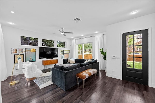 living room featuring dark hardwood / wood-style floors, ceiling fan, and plenty of natural light