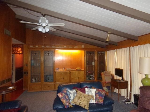 carpeted living room with lofted ceiling with beams and ceiling fan