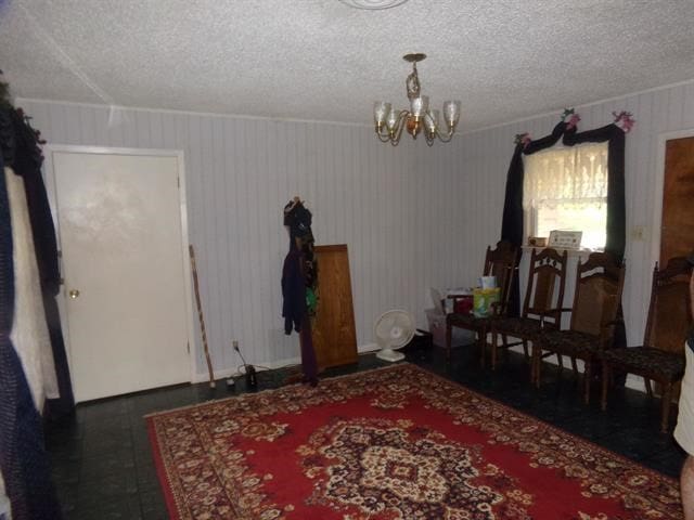 dining room featuring a notable chandelier, dark hardwood / wood-style flooring, and a textured ceiling