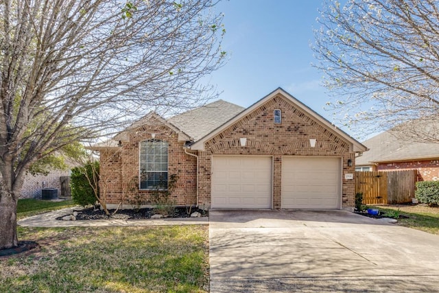 253 Lear Ave, Buda, TX 78610 - view of front of house featuring brick siding, a garage, and concrete driveway