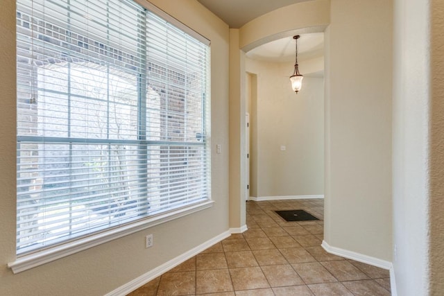 253 Lear Ave, Buda, TX 78610 - hallway with arched walkways and light tile patterned floors