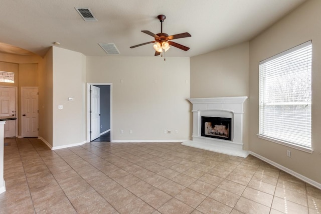 253 Lear Ave, Buda, TX 78610 - unfurnished living room with light tile patterned floors, a ceiling fan, and a fireplace with raised hearth