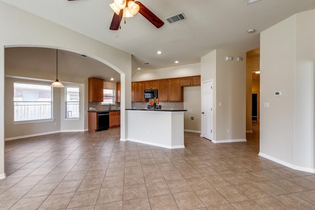 253 Lear Ave, Buda, TX 78610 - kitchen with dark countertops, open floor plan, black dishwasher, brown cabinetry, and tasteful backsplash