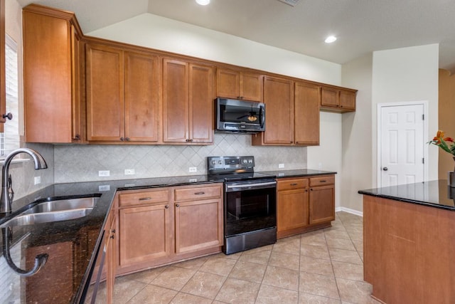 253 Lear Ave, Buda, TX 78610 - kitchen with stainless steel appliances, brown cabinetry, dark stone countertops, tasteful backsplash, and recessed lighting