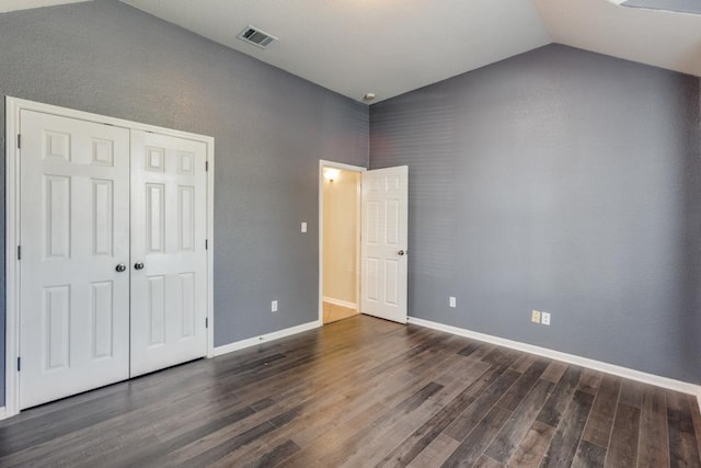 253 Lear Ave, Buda, TX 78610 - unfurnished bedroom featuring dark wood-type flooring, lofted ceiling, and a closet