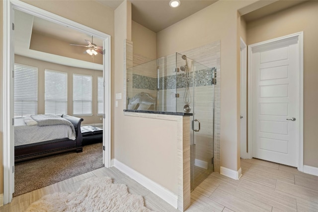 bathroom featuring walk in shower and ceiling fan